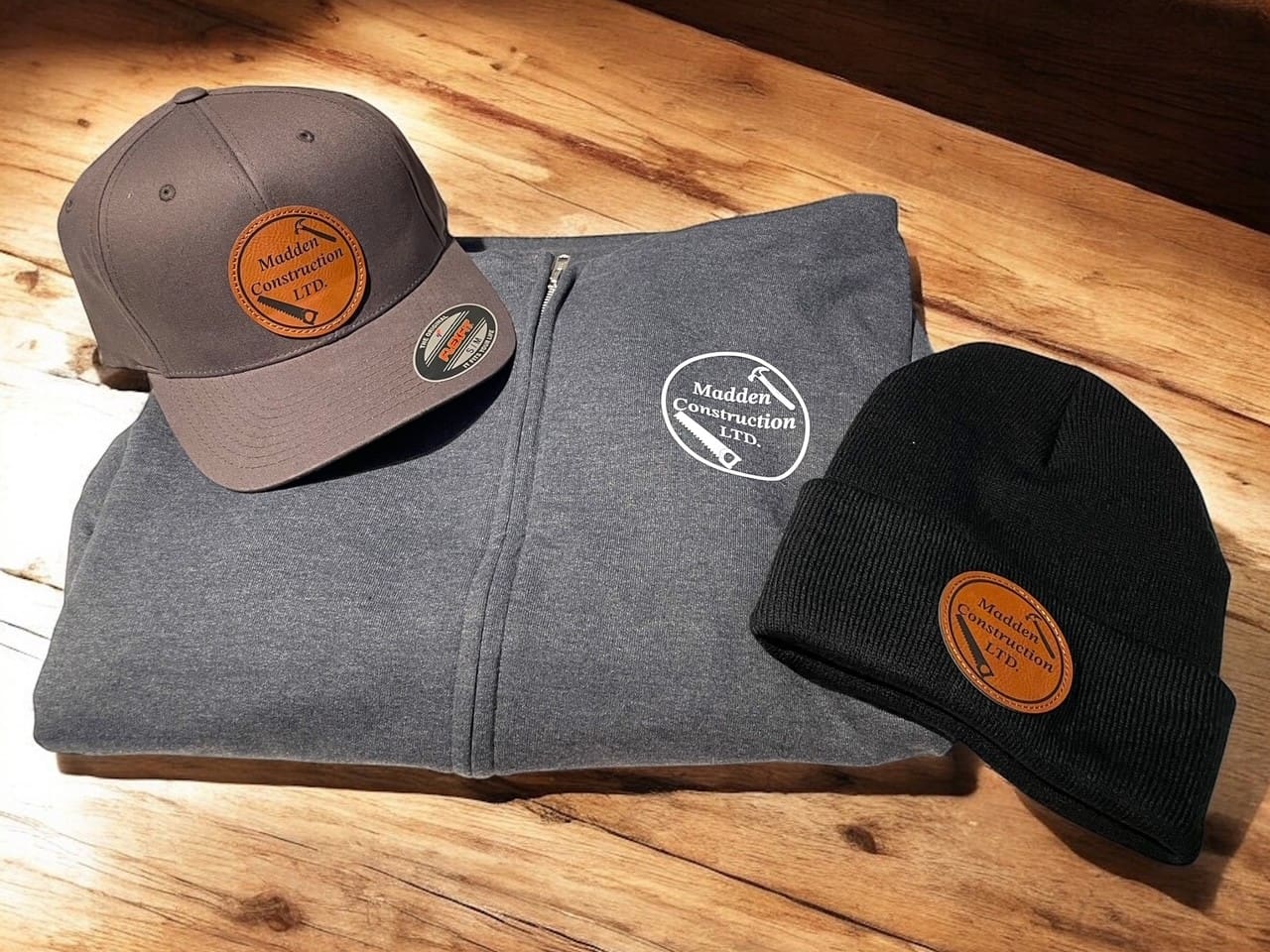 madden construction hat and sweater on wood background